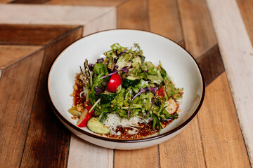 Fresh green salad with lettuce leaves. Healthy vegetarian meal close up.
