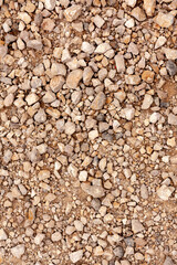 Loose gravel stones on dry ground
