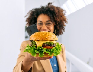 Woman holding a burger, talking on a phone