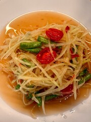 Som Tam Thai Papaya Salad, fresh spicy shredded green papaya with chili, lime, long beans and peanuts 