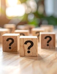 Wooden blocks with question marks on a table