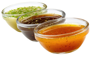 Three glass bowls of different sauces.  Each sauce has a distinct color and likely flavor profile.  The sauces are likely condiments for food, possibly for dipping