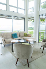 Bright modern living room with large windows and cozy seating area