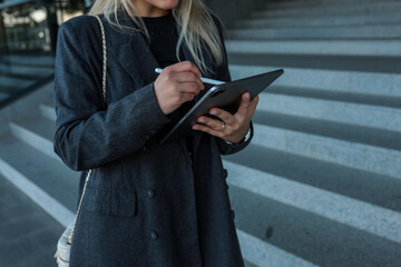 Businesswoman using tablet outdoors