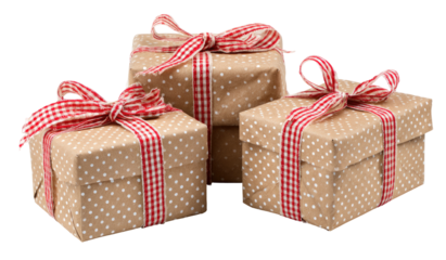 Three gift boxes, stacked, wrapped in kraft paper with polka dots and red ribbon bows