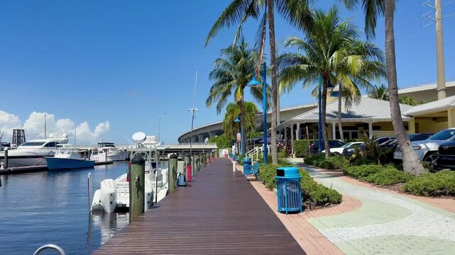 Walking along the Stuart Riverwalk boardwalk at the marina along the St. Lucie River in downtown Stuart in Martin County, Florida. 