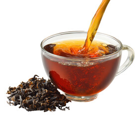 A transparent teacup filled with dark tea, hot liquid pouring in, and loose leaf tea beside it