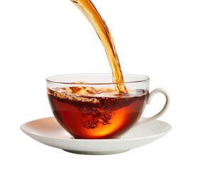 Hot tea being poured into a clear glass cup