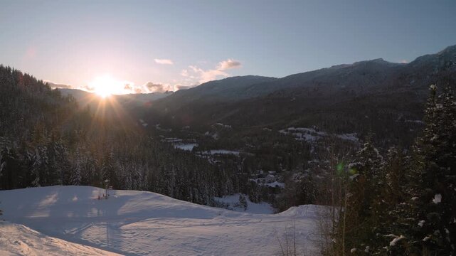 Mountain sunset over ski hill, Whistler, snow, forest. 4K 24FPS