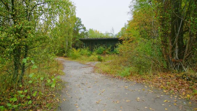 Footage capturing the desolate and overgrown remains of an abandoned cafe and river port in Pripyat, Ukraine, located within the Chernobyl Exclusion Zone. This video showcases the haunting beauty of n