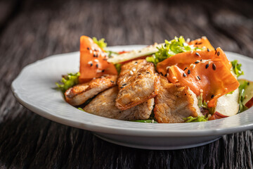 Fresh pork salad with vegetables and sesame seeds