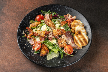 Caesar salad with chicken, bacon and parmesan