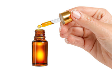 A hand holds a dropper bottle, amber-colored liquid is dispensed