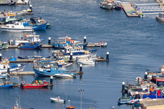 Fishing boats docked at setubal fishing port, portugal on a sunny day
