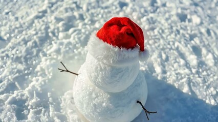 Snowman wearing Santa hat celebrating winter holiday outdoors, perfect for Christmas decoration, festive season, snowy background, joyful mood, December celebration, family fun, winter wonderland sce