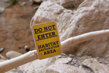 Temporary barrier made of tree branches and a metal sign, Tonto Natural Bridge park