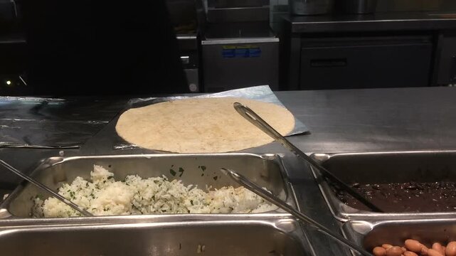Making burrito at restaurant