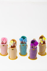 A row of makeup brushes are displayed in a case. The brushes are of different colors and sizes, and they are arranged in a way that makes them easy to access. The case is made of a soft material