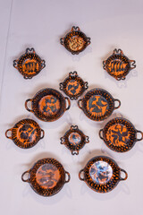 A collection of small, colorful bowls with various designs and patterns. The bowls are arranged in a row, with some overlapping each other. City of Puebla, Mexico, crafts