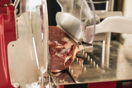 Italian meat slicer with a piece of meat inside