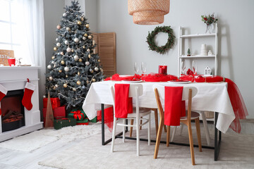 Interior of room with dining table, fireplace and Christmas tree