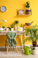Interior of room with green plants and table