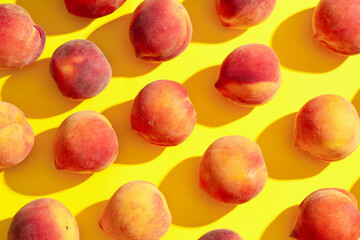 Sweet ripe peaches on yellow background