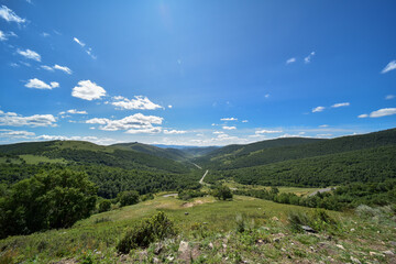 Vast Valley with Rolling Hills Under a Clear Blue Sky
