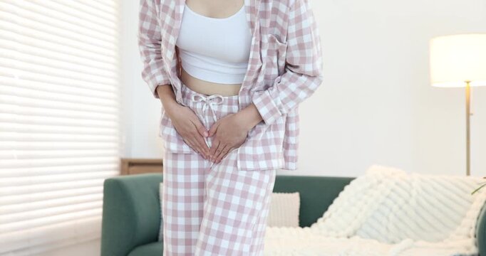 Woman suffering from cystitis symptoms at home, closeup