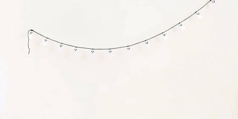 Minimal string lights hanging on white background in clean simple style, festive halloween and seasonal holiday decoration element, glowing graphic resource with bright atmosphere

