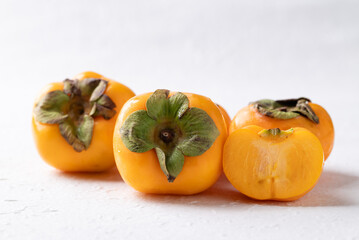 Fresh ripe persimmon on white background, Autumn sweet fruit