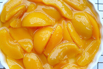 Sliced peaches in syrup served in a bowl