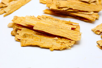 Dried Astragalus root slices used in traditional Chinese medicine.
