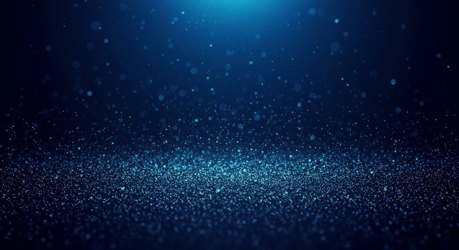 Dark blue abstract and ethereal background featuring a multitude of sparkling blue particles resembling glitter or dust. The denser concentration at the bottom gradually disperses upwards, creating a 