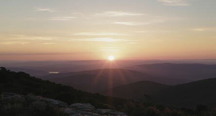 Sunset over mountain range, scenic landscape photography, golden hour, nature background, peaceful view