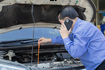 Garage small business or car insurance, middle-aged man calling for help while checking car engine, roadside situation reflecting breakdown problem, urgent communication for mechanical assistance