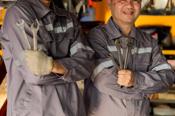 Family business owner, working together inspecting engine, garage small business partnership with...