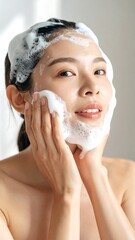 Woman washing face with foam