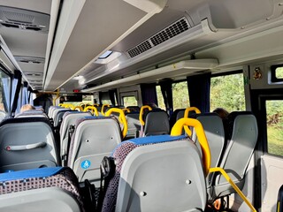 Comfortable bus interior with seats and handrails for public transport and travel