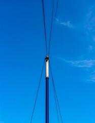 Blue mast, rigging, clear sky, nautical