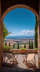 Obraz premium Picturesque Tuscan Landscape View Through Stone Arch with Deck Chairs Inviting Relaxation and Tranquility