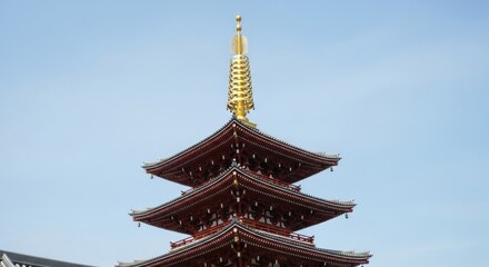 Fototapeta premium A majestic red wooden pagoda against a serene blue sky background