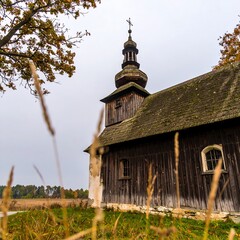 Wooden church in autumnal landscape