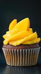 Delicious chocolate cupcake with vibrant yellow frosting topping.