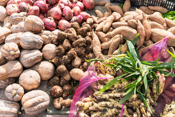 Display of different fresh root vegetables and tubers, showcasing a variety of produce for healthy eating.