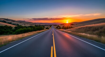 Scenic road leading to a vibrant sunset horizon over rolling hills offering a sense of adventure