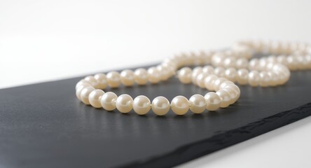 Elegant Pearl Necklace on Dark Surface, Jewelry Photography, Luxury Accessory, Close-Up Shot