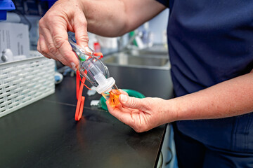 nurse setting up nebuliser medication and oxygen mask from cylinder for patient with asthma, gp general practice primary care health clinic Australia