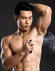 Athletic male model spraying deodorant after shower, fresh and clean energy
