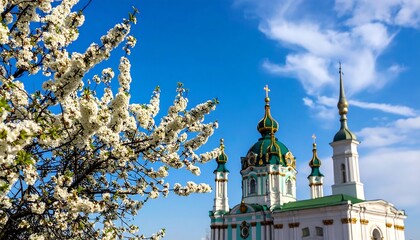 Blossoming trees frame a church against a vibrant sky